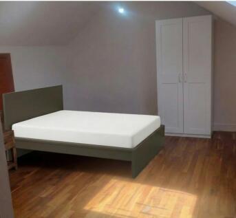 Bright bedroom with wooden floors and wardrobe...