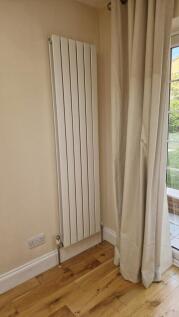 Modern radiator and stylish wooden flooring...