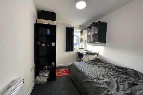 Bright, simply furnished single bedroom with a ...