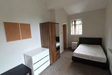 Bright bedroom with sleek furniture and storage...