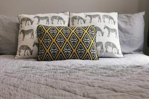 Comfy bed with stylish decorative cushions...