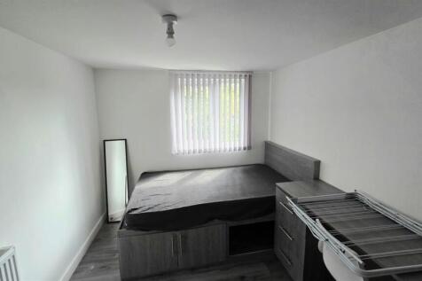 Bright bedroom with study desk and double bed...