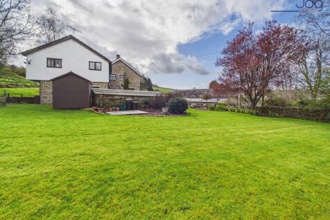 Tiered gardens with stream, stone terraces and open countryside backdrop