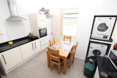 Bright kitchen with modern laundry and dining a...