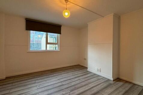 Bright bedroom with stylish wood-effect floorin...
