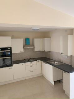 Bright modern kitchen with integrated appliance...