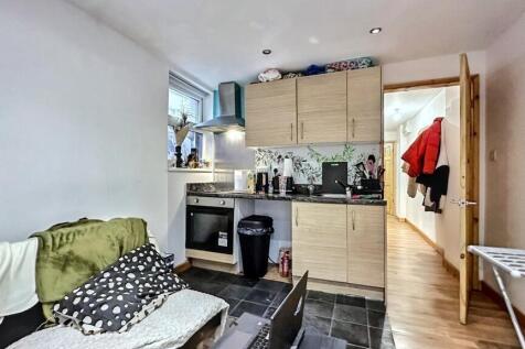 Bright kitchen with modern cabinets and seating...