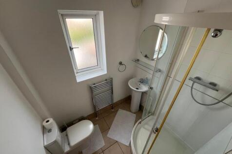 Bright, well-maintained bathroom with a corner ...
