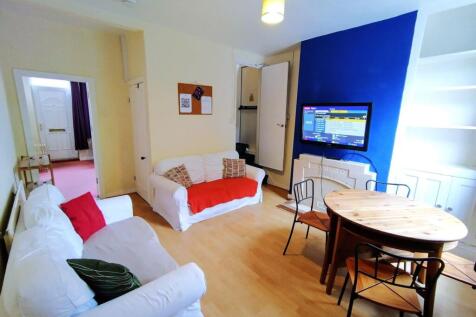 Bright, modern living/dining room with two whit...