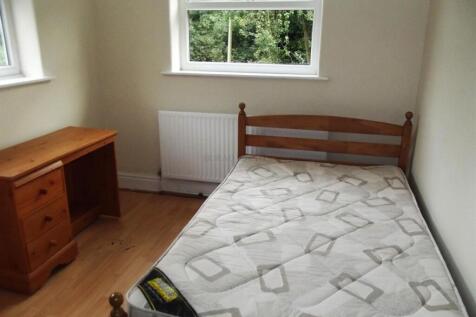 Bright bedroom with wooden desk and natural lig...