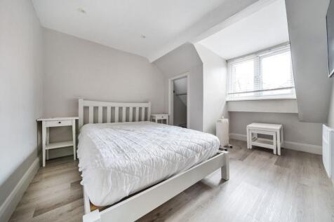 Bright modern double bedroom with wooden floors...