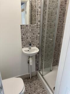 Modern bathroom with stylish patterned tiles...