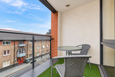 Crisp Urban Balcony with Rattan Seating.png
