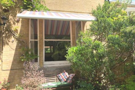 Private garden seating area with awning