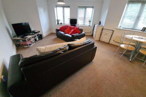 Bright and spacious living room featuring two l...