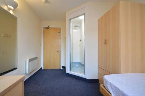 Modern bedroom with ensuite shower and storage...