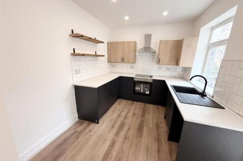 Modern kitchen with sleek dark cabinets....