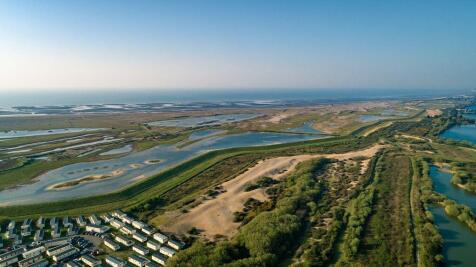 Aerial view of Rye Harbour Holiday Park beside nat