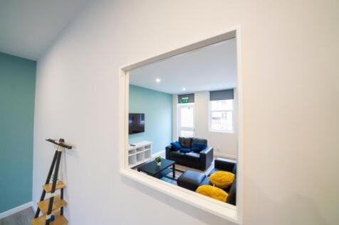 A modern, bright living room featuring comforta...