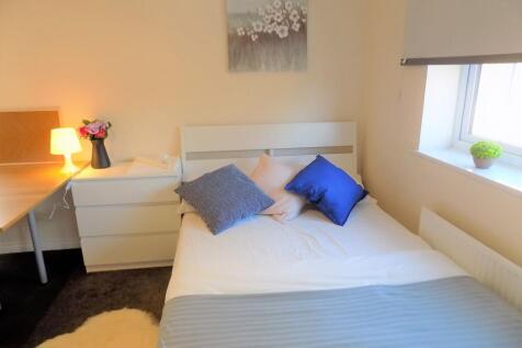 Bright, neatly styled bedroom with a comfortabl...