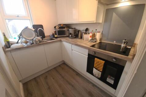 Bright and modern kitchen featuring sleek white...