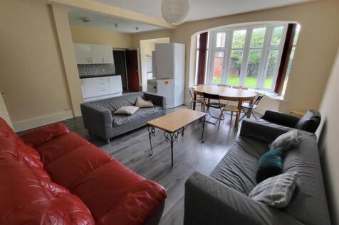 Bright, furnished living room with multiple sof...