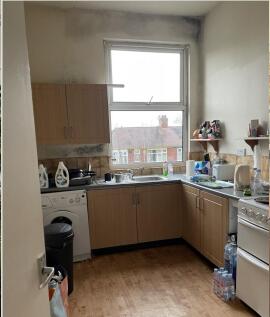 Bright corner kitchen with a large window overl...