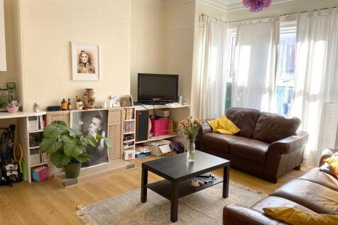 Bright, welcoming living room with large bay wi...