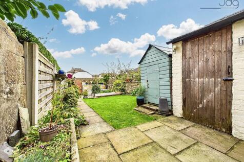 Back garden with storage sheds