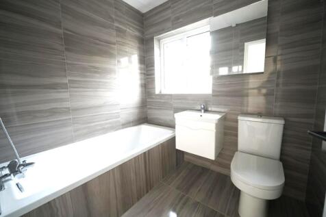 Contemporary tiled bathroom featuring a full-le...