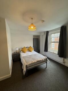 Bright and cozy double bedroom featuring a comf...