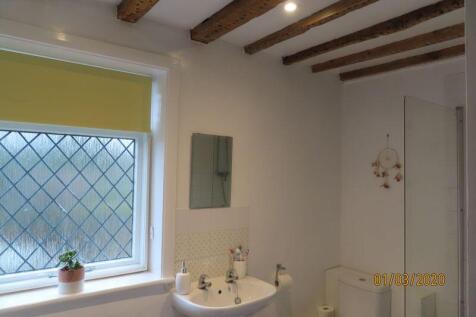 Timbered ceiling to pretty bathroom