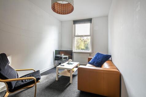 Bright living room with comfy seating and windo...