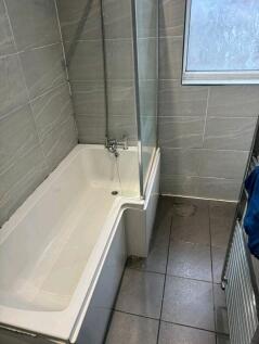Modern bathroom featuring a large L-shaped bath...