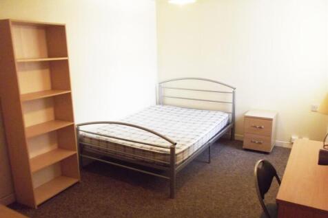 Bright, simply furnished bedroom with a metal d...