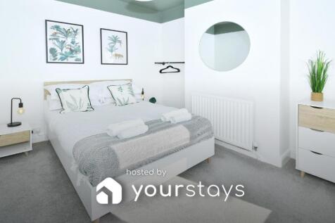 Bright, tastefully styled double bedroom with a...