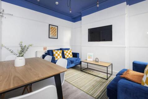 A spacious and inviting modern living room, per...