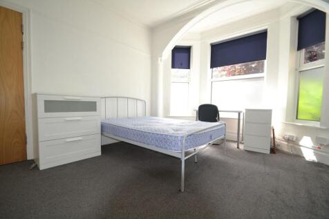 Bright and welcoming double bedroom featuring a...