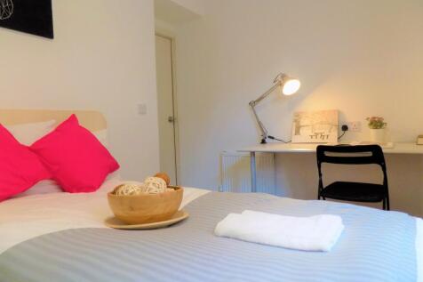 Bright and tidy single bedroom featuring a cozy...