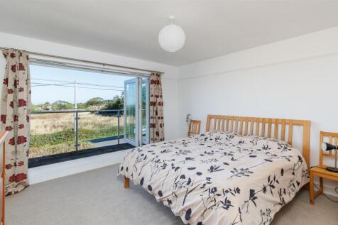 Principal bedroom with balcony and ensuite shower 