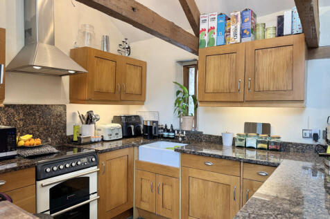 Kitchen with integrated appliances and granite worktops