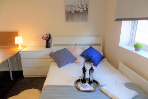 Bright, neatly styled bedroom with a comfy bed ...