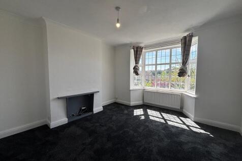 Bright living room with a spacious bay window...