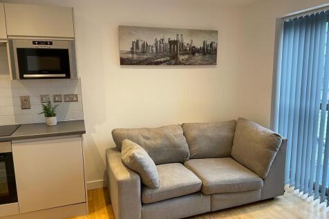 Modern living space with plush sofa and art...