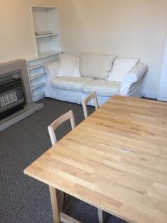 A cozy living room featuring a comfortable whit...