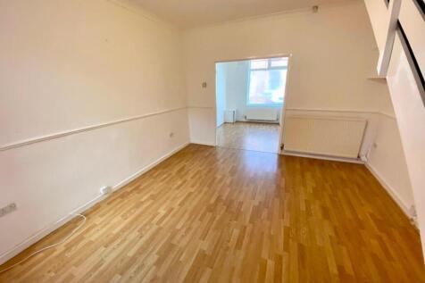 Bright, open-plan living area with warm wood-ef...