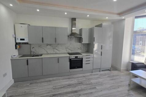 Modern fitted kitchen with sleek grey cabinets...