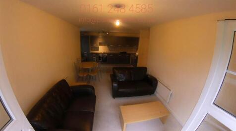 Bright, neutrally decorated living room with le...