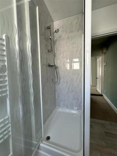 Modern walk-in shower with marble effect tiling...