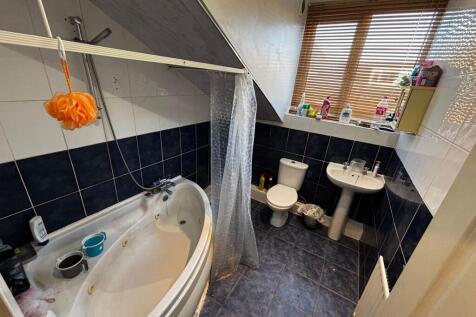 Bright bathroom with a corner jacuzzi-style bat...